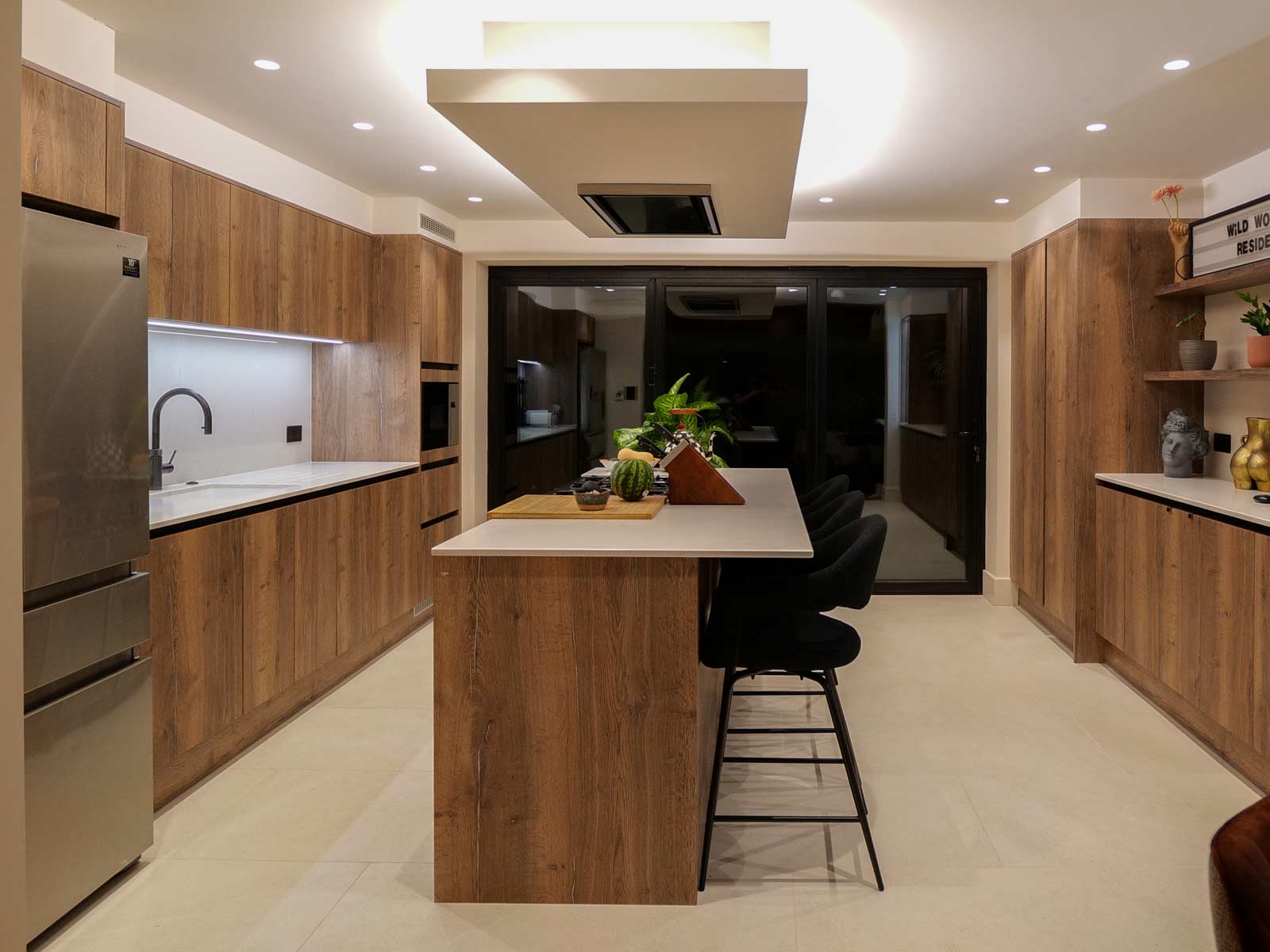 Charlie Brooks’ Scandi kitchen with a kitchen island with tall chairs