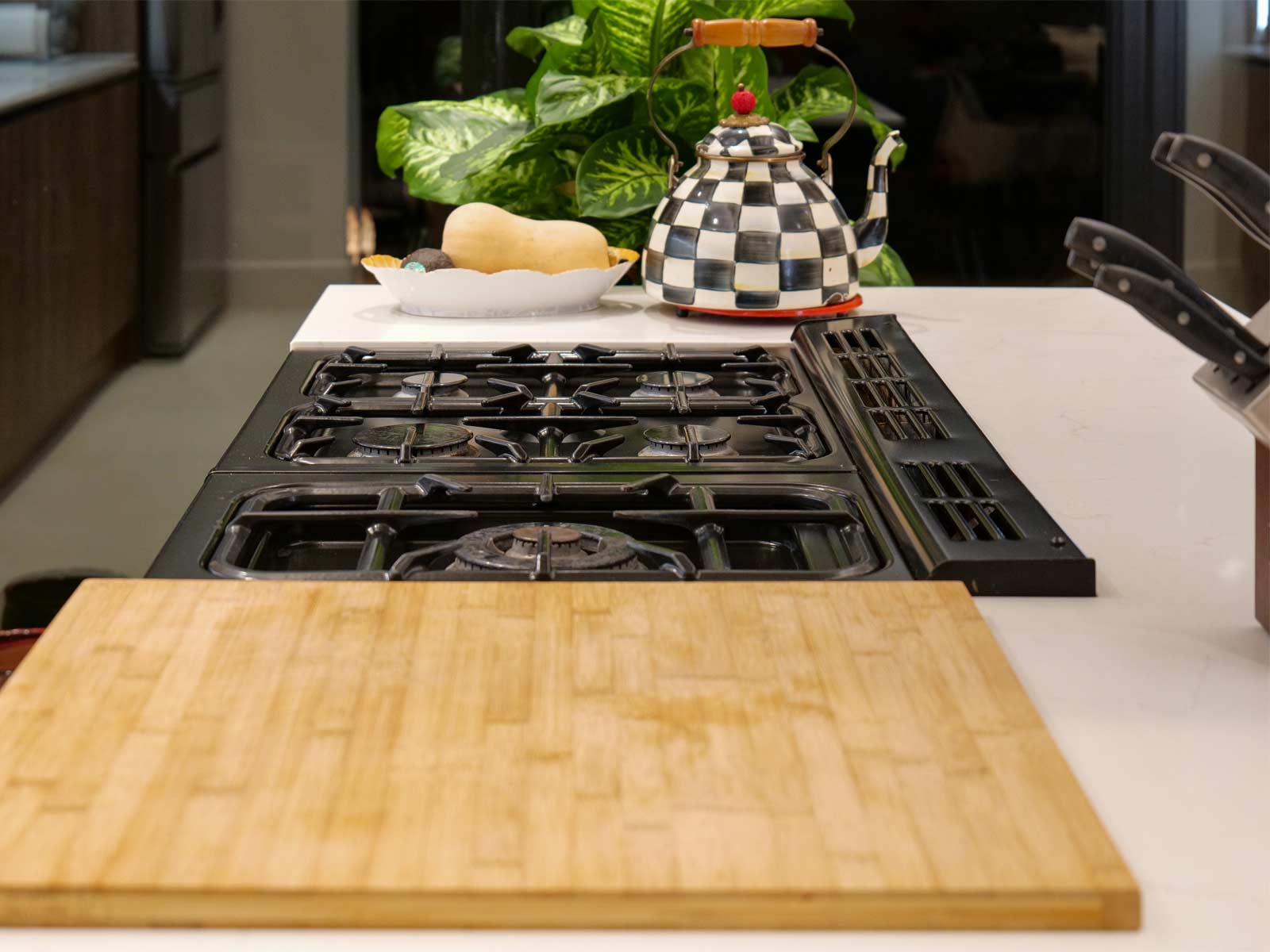 A Scandi kitchen island worktop with an oven and permanent chopping board