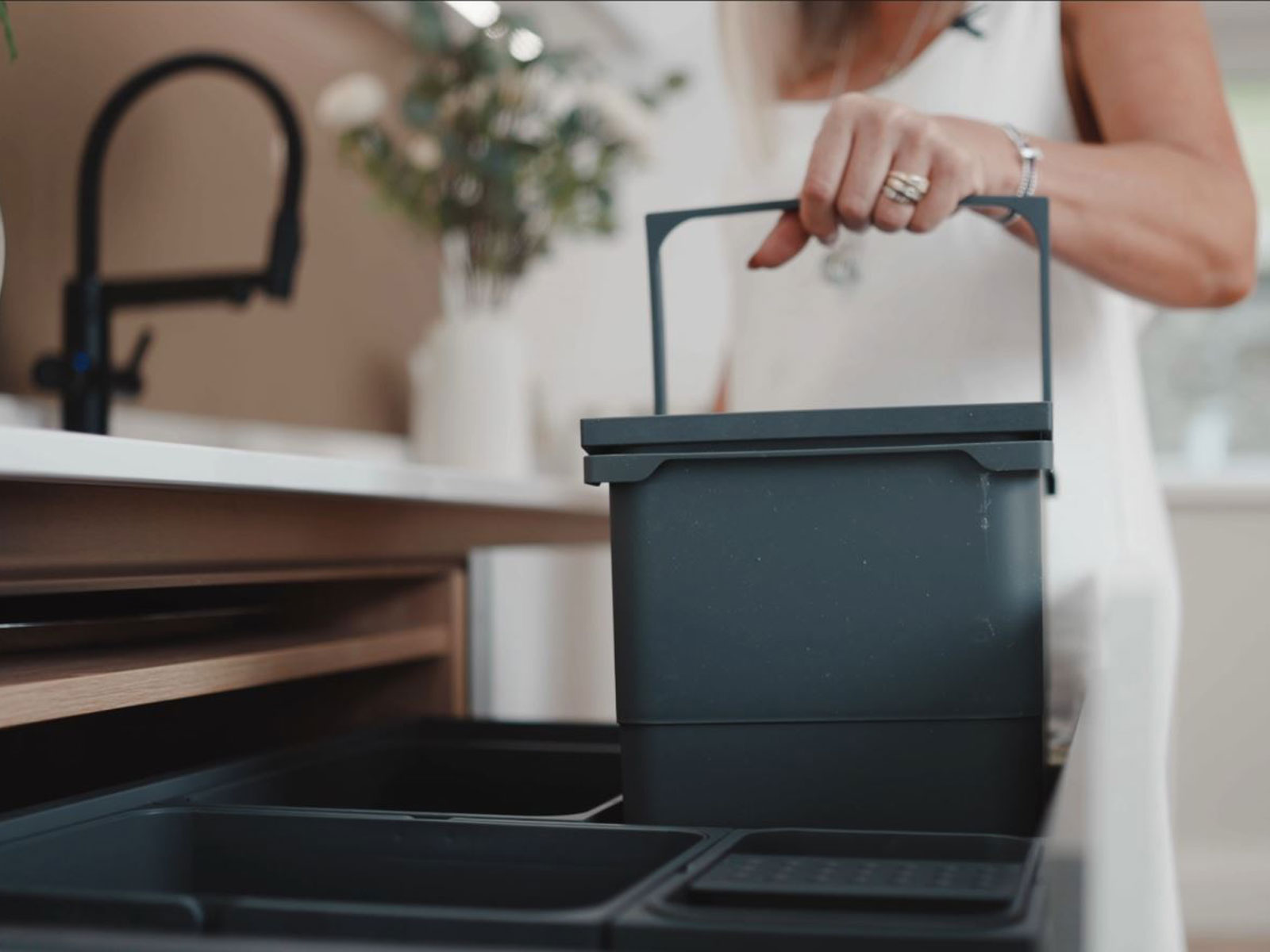 A concealed kitchen bin revealed in a Nordic-style interior