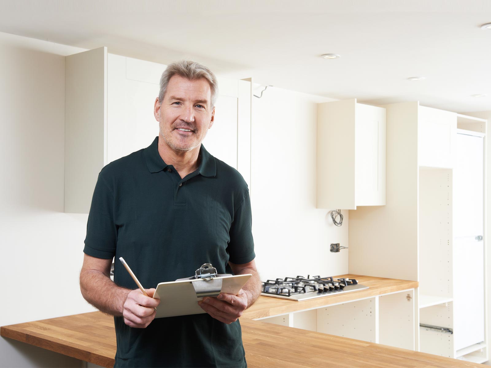 A private kitchen fitter inspecting the quality of a fitted kitchen