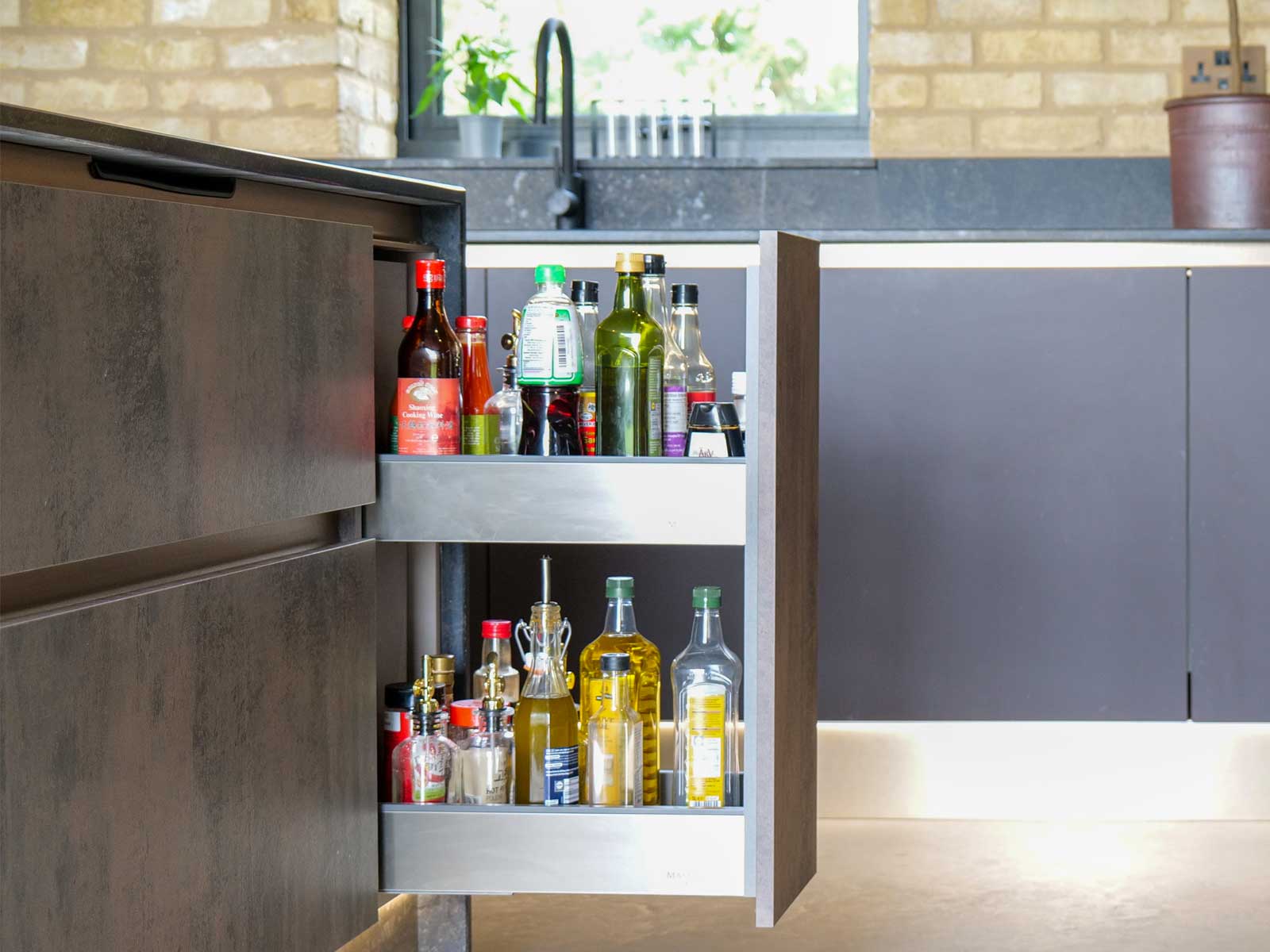 A modern pull-out larder in a handleless kitchen