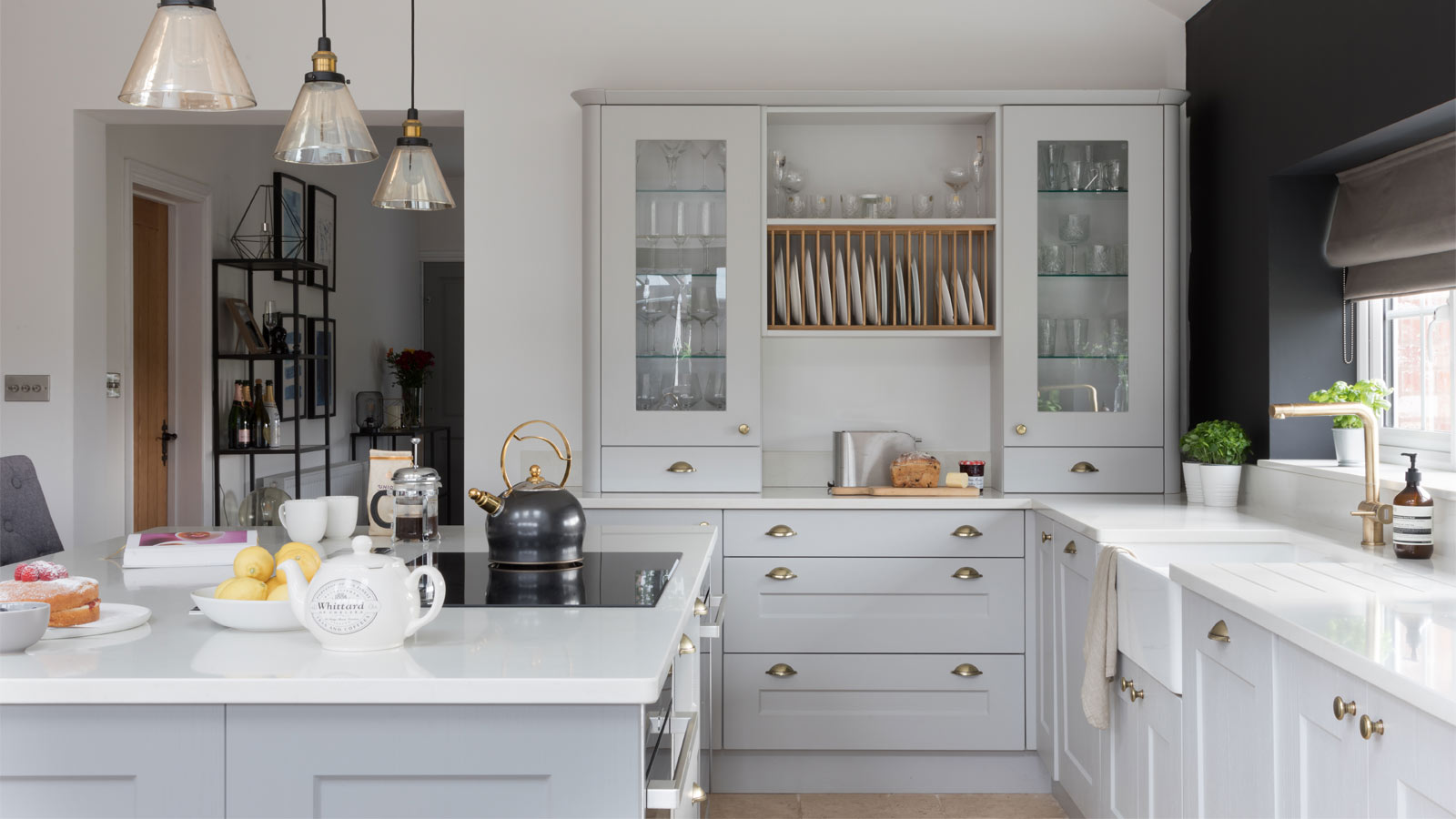 A Nancy Meyers kitchen sporting Shaker cupboards and white marble worktops