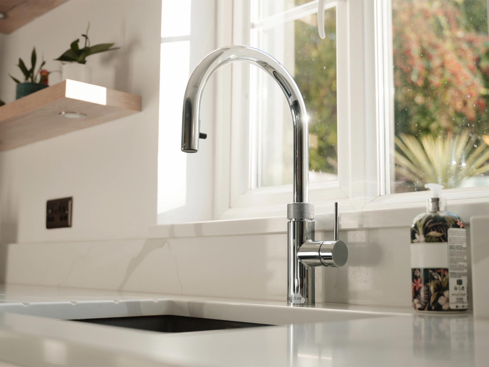 A white handleless kitchen worktop featuring a boiling water tap