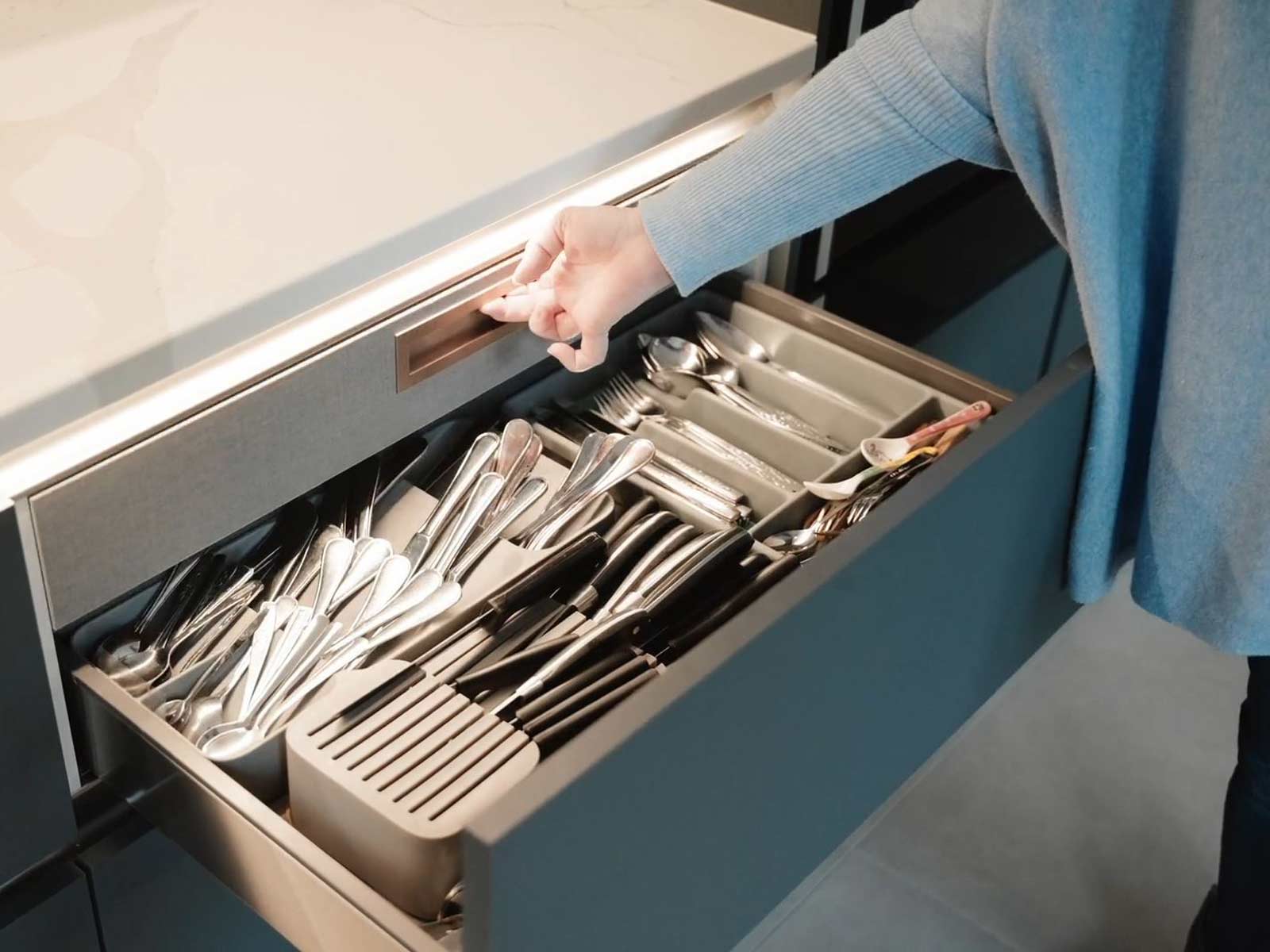 A steel drawer with the effect of a metal kitchen drawer organiser