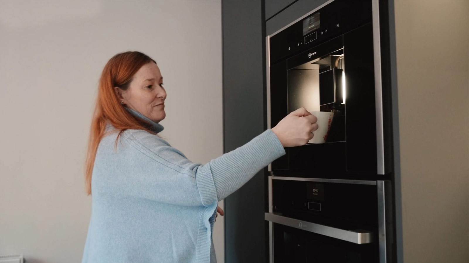 Lisa with her Neff coffee machine, which kitchen cabinet makers installed