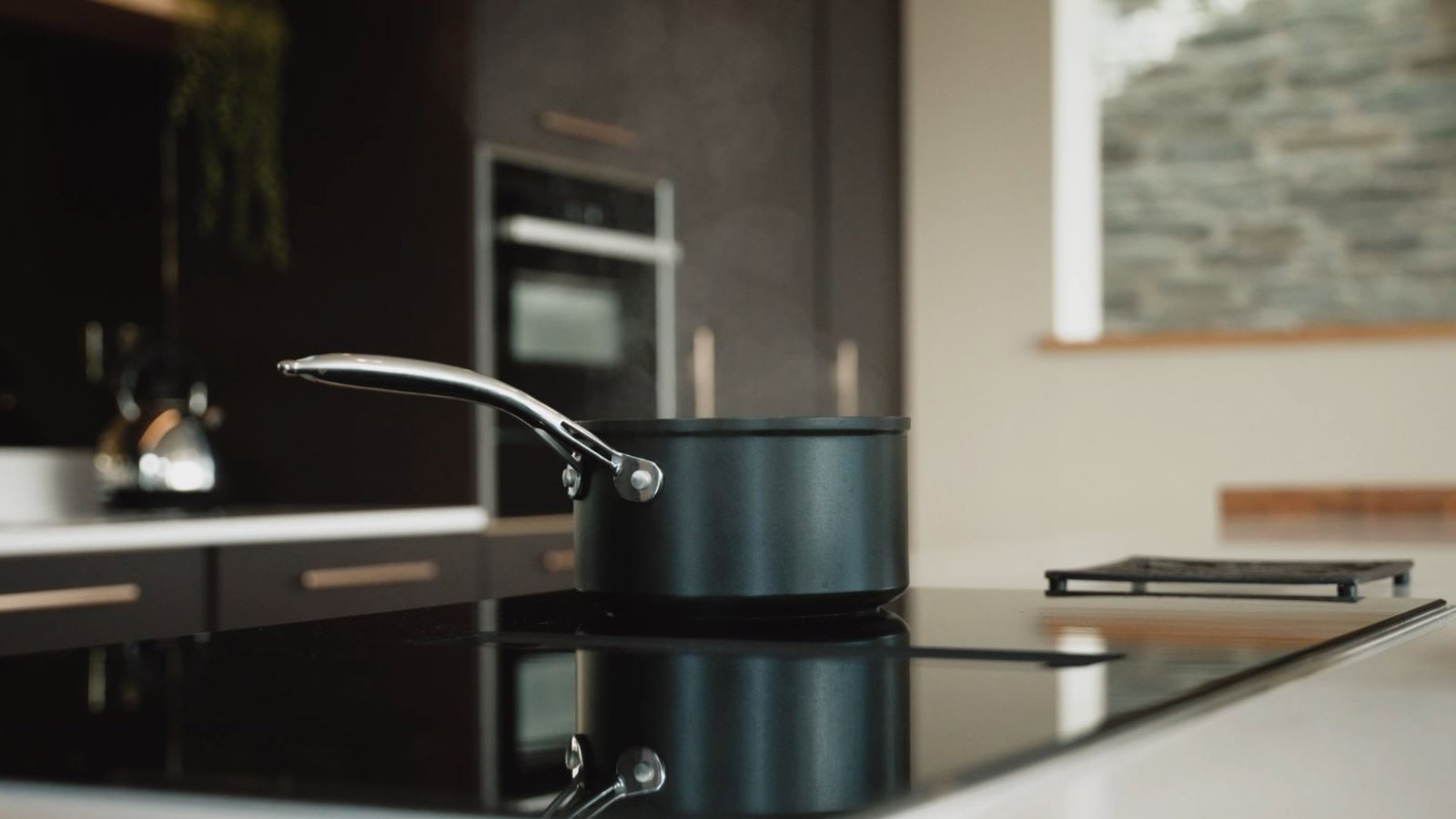 A modern kitchen design and fitting for an integrated oven extractor fan