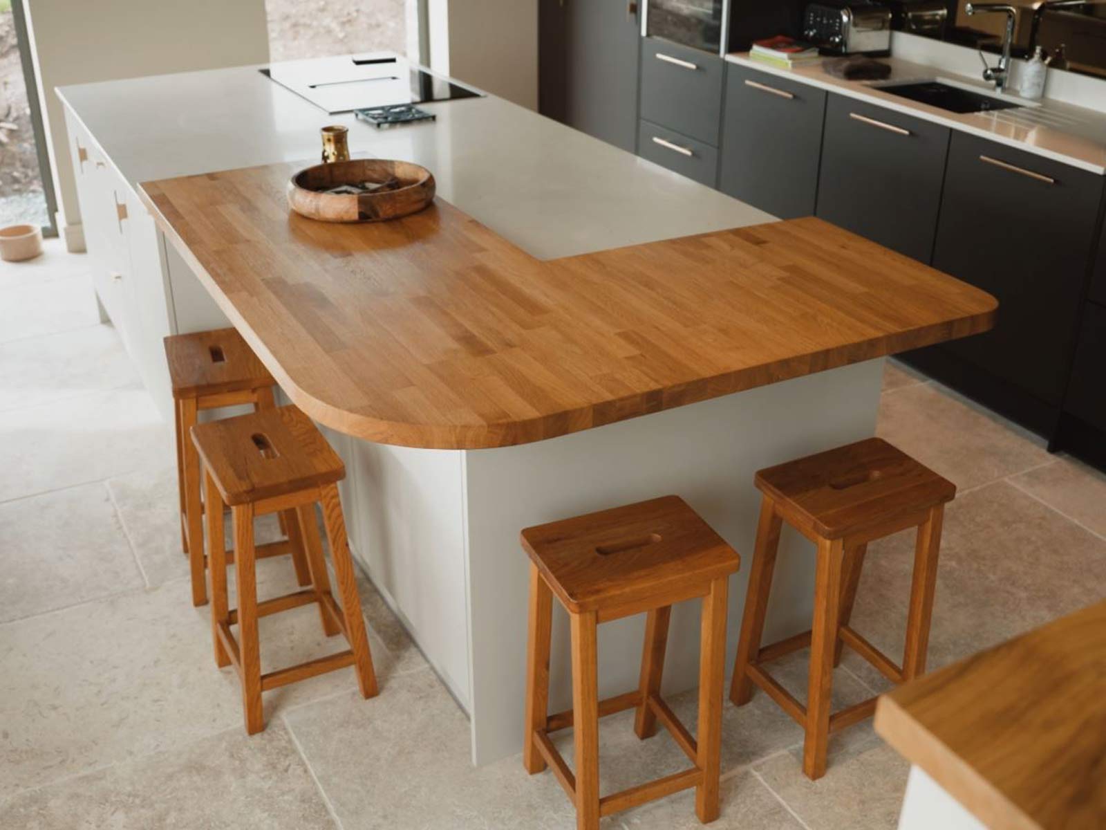 A kitchen island with bar stools from a premium kitchen design company