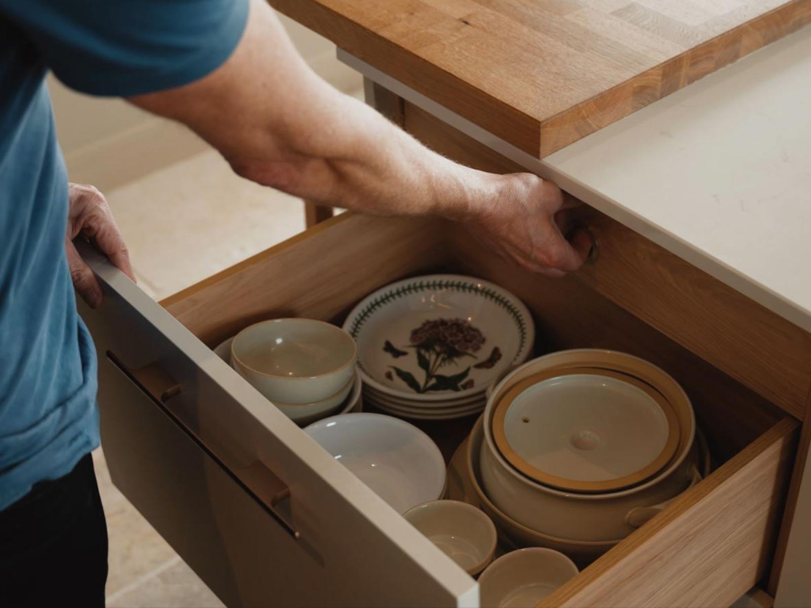 Deep kitchen drawers in Portland Oak full of plates and dishes