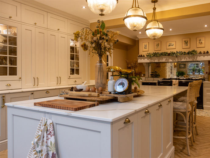 A Mediterranean kitchen with greige cabinets and brass handles