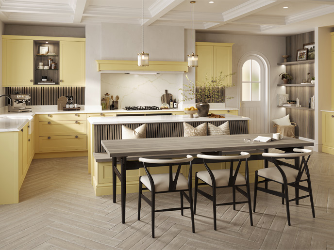 A Mediterranean kitchen with soft yellow cabinets and pale counters