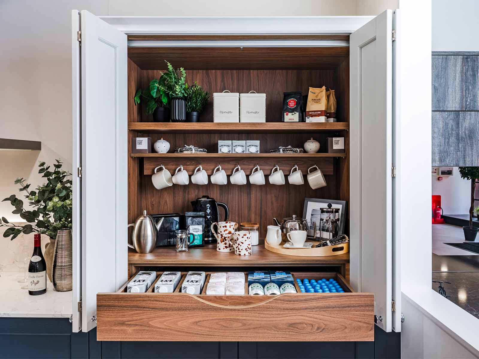 A tea station and food storage solutions within a breakfast cupboard