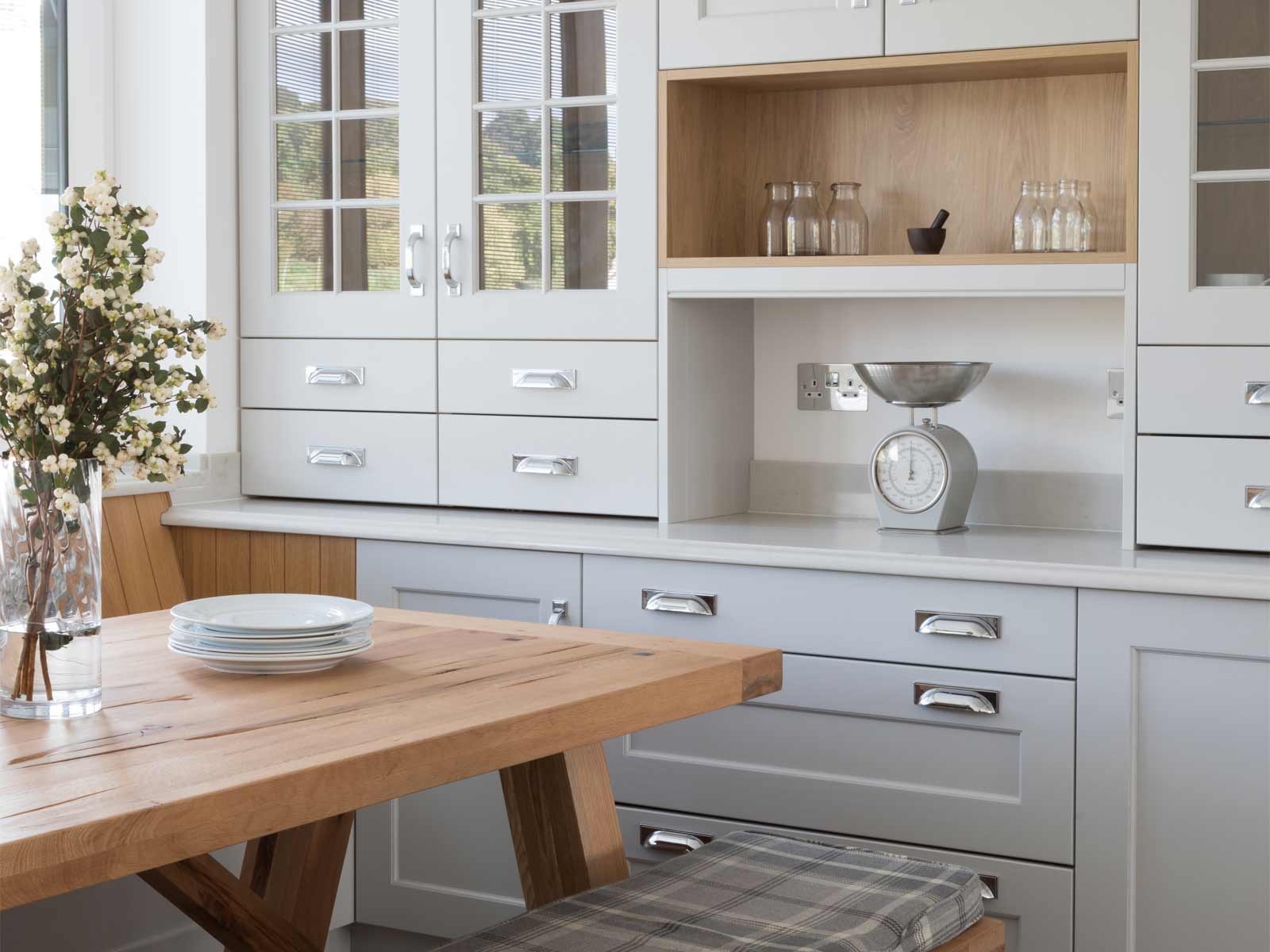 A floral kitchen with wooden wall panelling and rustic aesthetics