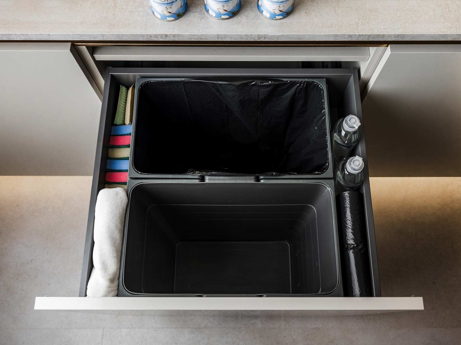 A Swedish-style kitchen bin, hidden in a white cupboard