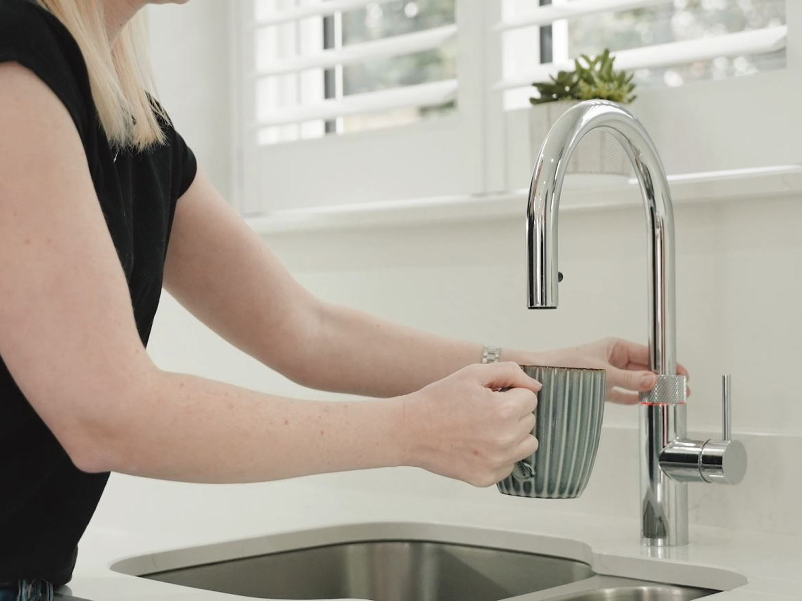 A kitchen declutter idea: the boiling water tap, demonstrated by Suzanne