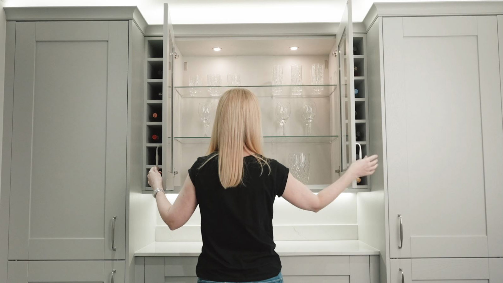 Pantry kitchen storage cabinets surrounding a spotlit display